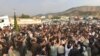 Iranian Kurdish members of the Qadiriyya sect of Sufi Islam gather at the Bashmakh border crossing between Iran and Iraq on July 9, 2020, as hundreds of them dash into Iraqi territory to attend the funeral of their spiritual leader. (VOA Kurdish)
