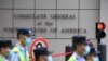 FILE - Policemen walk past the US consulate in Chengdu, southwestern China's Sichuan province, July 26, 2020. 