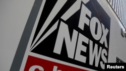 FILE — In this undated photo, a Fox News sign identifies a vehicle in New York. Former Donald Trump supporter Ray Epps has filed a defamation lawsuit against Fox News, saying the network made him a scapegoat for the U.S. Capitol insurrection.