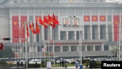 People walk near the venue of a ruling party congress in Pyongyang, North Korea, May 6, 2016. 