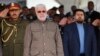 FILE - Abu Mahdi al-Muhindis, center, Deputy Chairman of al-Hashd al-Shaabi, an Iraqi Shiite militia, attends a ceremony marking Police Day at the police academy in Baghdad, Iraq, Jan. 9, 2016. 