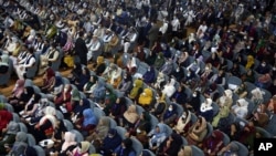 Delegates wearing a protective face masks to help curb the spread of the coronavirus, attend on the first day of the Afghan Loya Jirga meeting in Kabul, Afghanistan, Aug. 7, 2020.