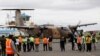 A Kenyan military aircraft carrying some of the bodies of those killed in the Mandera quarry attack, arrives at Wilson Airport in Nairobi, Kenya,Tuesday, Dec. 2, 2014.
