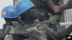 UN forces patrol on a street in Abidjan, Ivory Coast, after UN chief warns that Ivory Coast faces 'real risk' of return to civil war, Dec 22, 2010