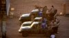 FILE - Members of Sudan's intelligence services shoot bullets in the air at the headquarters of the Directorate of General Intelligence Service, in the Riyadh district of the capital Khartoum, Jan. 14, 2020. 