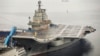 FILE - China's first aircraft carrier, which was renovated from an old aircraft carrier that China bought from Ukraine in 1998, is seen docked at Dalian Port, in Dalian, Liaoning province September 22, 2012. 