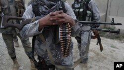 FILE - Afghan security forces guard a checkpoint at the border with Pakistan, Kandahar province, Afghanistan, Jan. 25, 2016. 