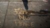 Messages written in a parking lot protest the shooting of Michael Brown in Ferguson, Missouri, Aug. 15, 2014.