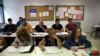 FILE - Victor Antu–a of Spain (top R) and Felipe Barbosa of Colombia (top 2nd R) attend an English class at an Adults Education Centre in Madrid.