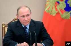 Russian President Vladimir Putin chairs a Security Council meeting in Moscow, June 16, 2017.