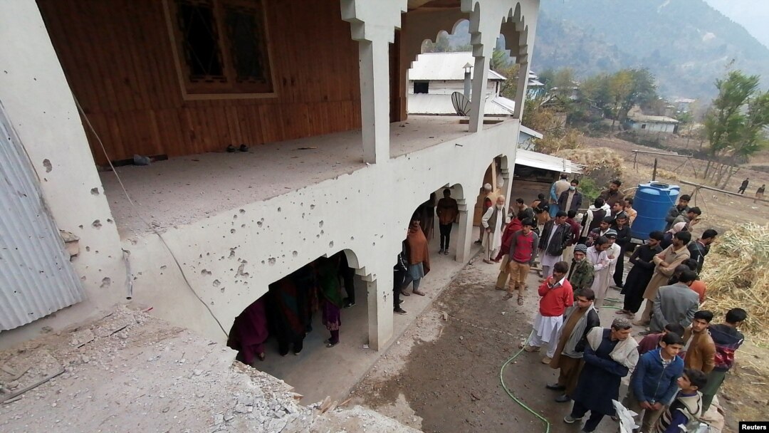 Locals gather near a house that was damaged, according to them, by cross-border shelling, in Neelum Valley, in Pakistan-administrated Kashmir, Nov. 13, 2020.