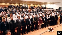 Newly elected lawmakers attend the first parliament session in Baghdad, Iraq, Jan. 9, 2022. 