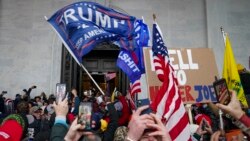 FILE - Insurrections loyal to President Donald Trump riot outside the Capitol, Jan. 6, 2021, in Washington.
