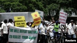 FILE - Supporters of the Zimbabwe African National Union's Patriotic Front (ZANU-PF) march in Harare, Feb. 24, 2010, to protest against a European Union decision to extend economic sanctions on Zimbabwe.