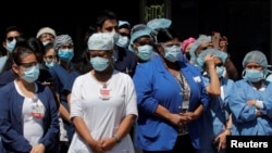 Health care workers gather for lunch purchased by members of the New York City Police Department (NYPD) outside the Brooklyn Hospital Center, during the outbreak of coronavirus disease (COVID-19) in the Brooklyn borough of New York City, April 28, 2020.