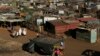 A fruit vendor waits for customers at an informal settlement in Thokoza, south of Johannesburg, South Africa, July 18, 2014. 