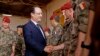 French president Francois Hollande, front left, greets French troops as he arrives at the French military operation headquarters at M'Poko airport in Bangui, Central African Republic, Feb. 28, 2014.
