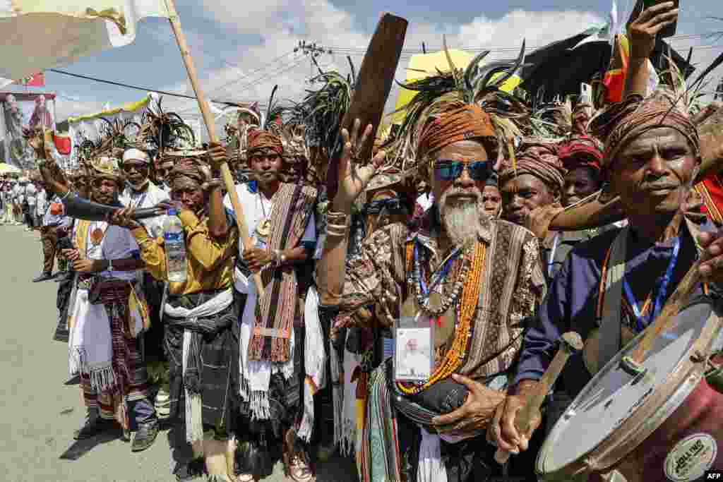 Catholic faithful wait on a street to welcome Pope Francis in Dili. Catholic devotees were clamoring to see Pope Francis before his arrival in East Timor's capital -- making pilgrimages from faraway towns and hours-long crossings of its shared border with Indonesia.