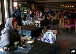 Young people spend their time at a cafe in downtown Tehran, Iran, Jan. 3, 2018. Young people spend their time at a cafe in downtown Tehran, Iran, Jan. 3, 2018. Unemployment among young people is 28 percent.
