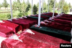 FILE - Coffins containing the bodies of Afghan national Army (ANA) soldiers killed in an April 21 attack on an army base are lined up in Mazar-i-Sharif, northern Afghanistan, April 22, 2017. The attack killed more than 140 Afghan soldiers.