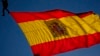 FILE - A Spanish flag flies in Madrid, Spain, Oct. 12, 2021. Iranian handball player Shaghayegh Bapiri defected to Spain in December 2021.