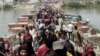 Displaced Sunni people fleeing Ramadi cross a bridge outside Baghdad, May 24, 2015. Iraqi forces recaptured territory from advancing Islamic State militants near the recently fallen city of Ramadi on Sunday.