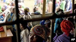 A Congolese woman refugee sits with others at the Nkamira transit centre for refugees in western Rwanda Saturday, May 5, 2012.