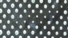 Close-up of an artwork created with screws and washers.
