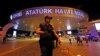 FILE - A police officer stands guard at the entrance of the Ataturk airport in Istanbul, Turkey, June 29, 2016.