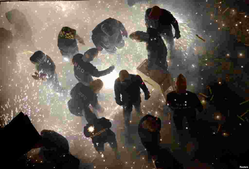 Revelers play with fireworks during the annual "Corda" festival in the village of Paterna near Valencia, Spain.