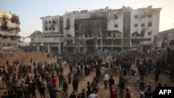 Palestinians inspect the damage outside Gaza's Al-Shifa hospital after the Israeli military withdrew from the complex housing the hospital on April 1, 2024.
