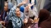 Relatives and families of members of Muslim Brotherhood and supporters of ousted President Mohamed Morsi react after hearing the sentence, in front of the court in Minya, south of Cairo, Apr. 28, 2014. 