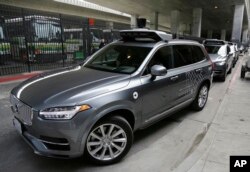 In this photo taken Dec. 13, 2016, an Uber driverless car heads out for a test drive in San Francisco.