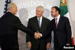 U.S. Secretary of State Rex Tillerson (center) looks at Secretary of Homeland Security John Kelly as he shakes hands with Mexico's Foreign Secretary Luis Videgaray (right) after delivering statements at the Ministry of Foreign Affairs in Mexico City, Feb.