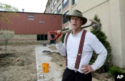 In this April 25, 2017 photo, Stephen Faulkner, owner of Faulkner's Landscaping & Nursery, works on a landscape project in Manchester, New Hampshire. Innkeepers, restaurateurs and landscapers around the U.S. say they’re struggling to find help.