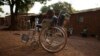 Giovanni Mougounou, 10, who lost both legs in April 2013 to what his family say was a rocket-propelled grenade launched by Seleka fighters on a church, pushes his wheel chair in the Boy Rabe district of Bangui, Central African Republic, February 4, 2014.
