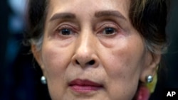 FILE: Myanmar's leader Aung San Suu Kyi waits to address judges of the International Court of Justice on the second day of three days of hearings in The Hague, Netherlands on Dec. 11, 2019. 