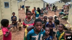 FILE - Children of around 6,000 ethnic Fulanis who have been displaced by attacks, gather in a makeshift camp for the displaced in Youba in Yatenga province in Burkina Faso, April 20, 2020.
