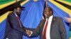 FILE - South Sudan's President Salva Kiir, left, shakes hands with rebel leader and former vice president Riek Machar after signing an agreement to reunify their political party in Arusha, Tanzania, Jan. 21, 2015.