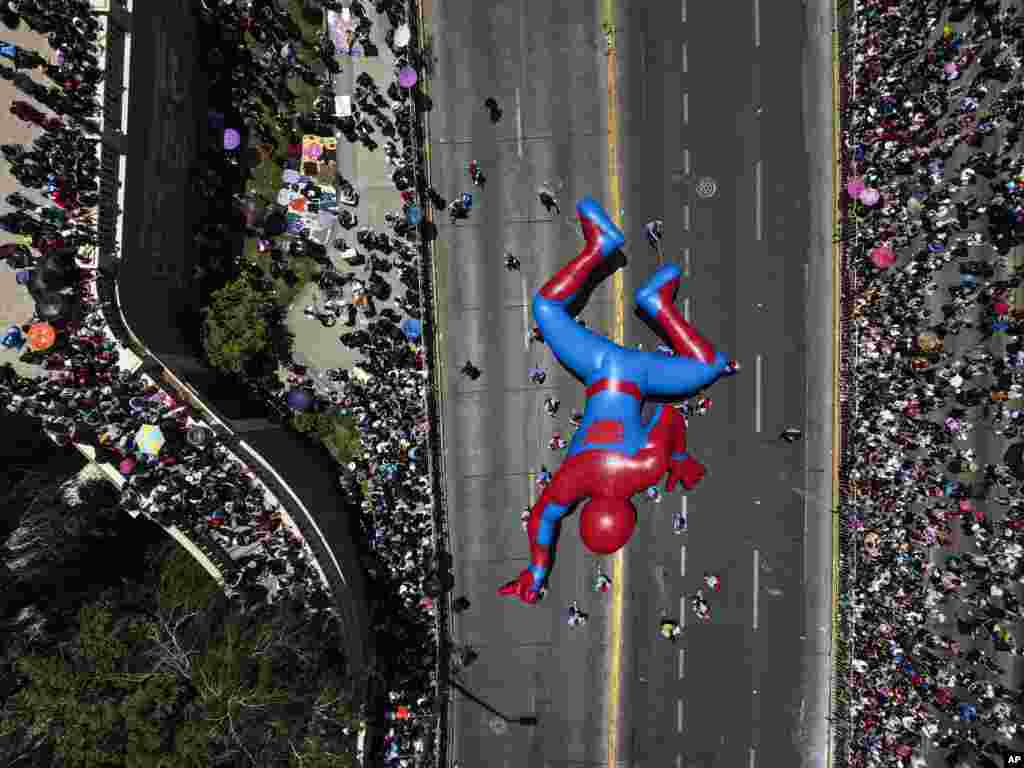 A Spiderman balloon passes through a street during a Christmas festival in Santiago, Chile, Dec. 1, 2024.