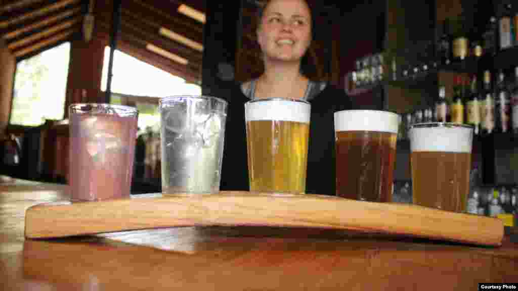 “South Africans have such a specific taste bud range," says Nuschka Botha of Black Hose Brewery, displaying tasters of her brews. "We don’t want to go way out and try something crazy.” (Photo Credit: Darren Taylor)
