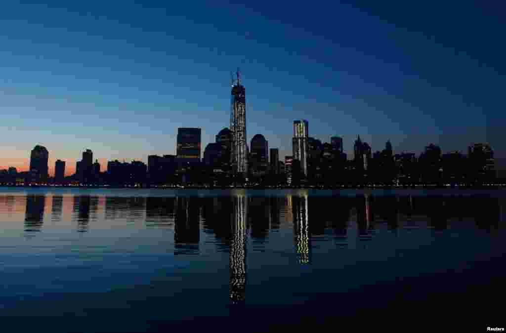 One World Trade Center in New York is reflected in the Hudson River as seen from Jersey City, New Jersey, May 10, 2013.