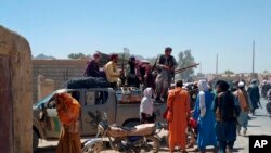 Taliban fighters patrol inside the city of Farah, capital of Farah province, southwest Afghanistan, Aug. 11, 2021. 