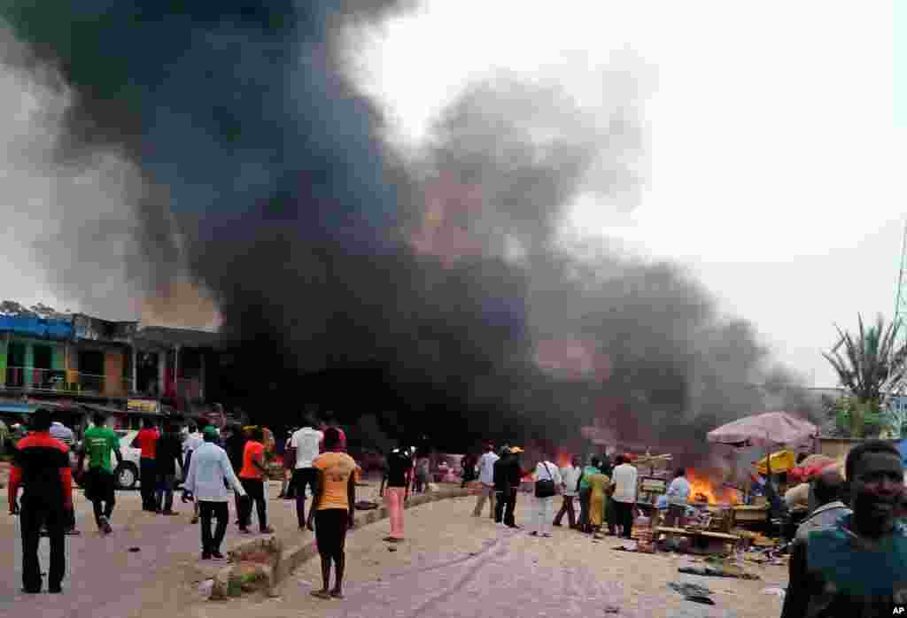 Smoke rises after a bomb blast at a bus terminal in Jos, Nigeria, May 20, 2014.