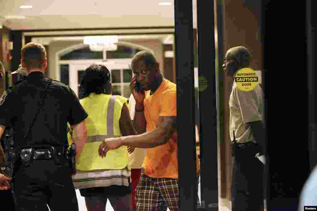 A person seeks information about a relative as police respond to a shooting at the Emanuel AME Church in Charleston, South Carolina, June 17, 2015.