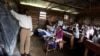 FILE - A teacher conducts a mathematics lesson to high school students in Democratic Republic of Congo town of Bunagana, Oct. 19, 2012. Many teachers are paid months late.