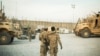 A U.S. soldier from the 3rd Cavalry Regiment walks with the unit's Afghan interpreter before a mission, Dec. 11, 2014. 
