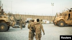 A U.S. soldier from the 3rd Cavalry Regiment walks with the unit's Afghan interpreter before a mission, Dec. 11, 2014. 