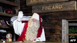 FILE - Santa Claus waves to his visitors as they leave his office in Santa Park near Rovaniemi, Finnish Lapland, on Dec. 14, 2011.