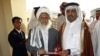 Qatari Assistant Minister for Foreign Affairs Ali bin Fahd al-Hajri (r) and Jan Mohammad Madani, (l) one of the Taliban officials cut the ribbon at the official opening ceremony of a Taliban office in Doha, Qatar, June 18, 2013. 